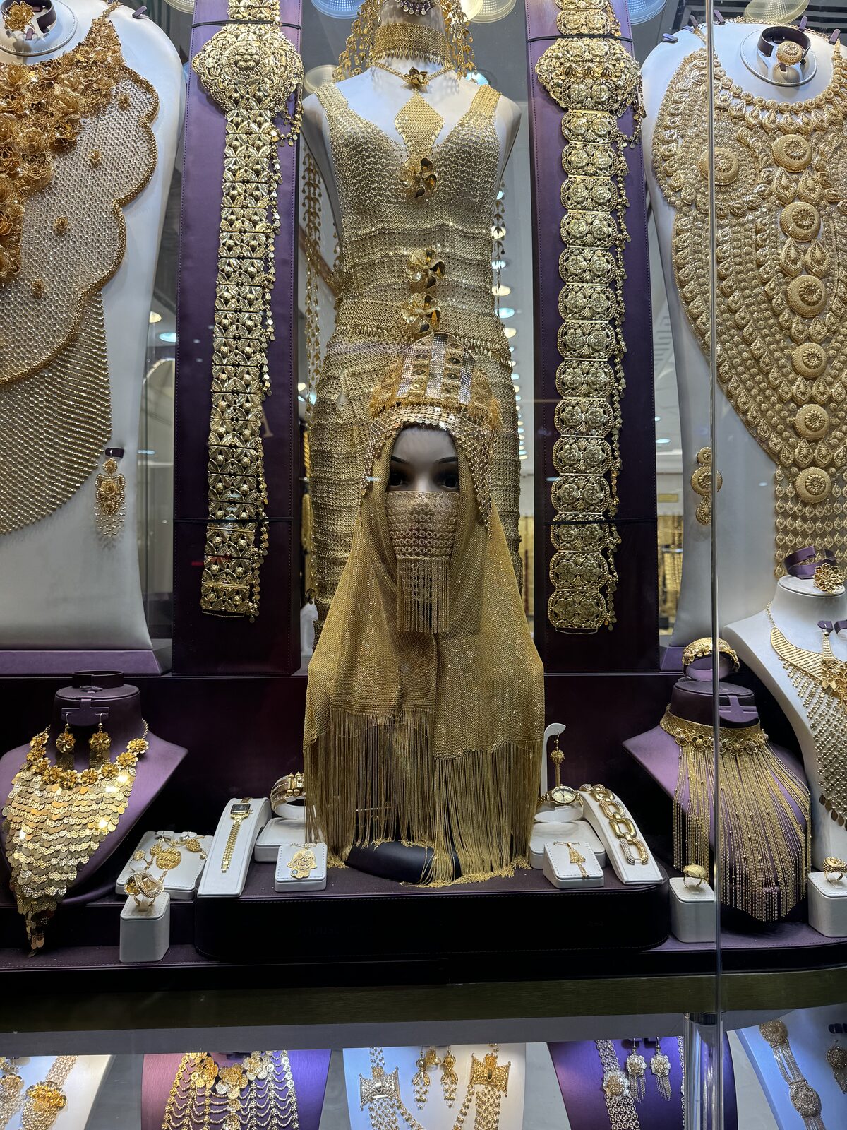 Vestido e véu totalmente cobertos de joias de ouro em exposição no mercado de Deira